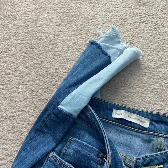 Distresses ankle bottom with a lighter color denim on back. Script - Picture 4 of 5